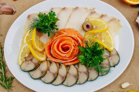 Autumn table setting with pumpkins. Thanksgiving dinner. fish platter with lemon in a white plateの写真素材