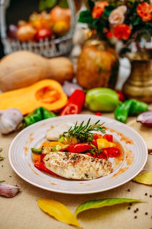 Autumn table setting with pumpkins. Thanksgiving dinner.grilled chicken breast with vegetablesの写真素材