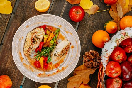 Autumn table setting with pumpkins. Thanksgiving dinner.grilled chicken breast with vegetablesの写真素材