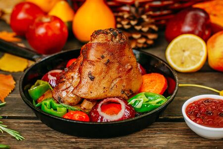 Autumn table setting with pumpkins. Thanksgiving dinner.baked pork shank with vegetablesの写真素材