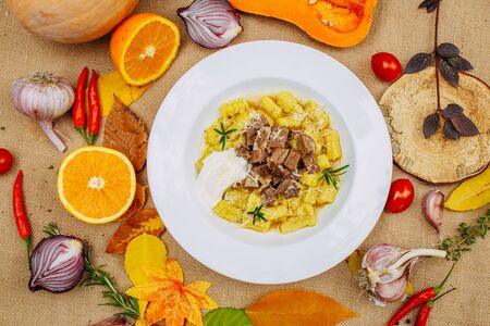 Autumn table setting with pumpkins. Thanksgiving dinner.sliced ââboiled dough with meatの写真素材