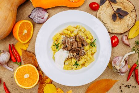 Autumn table setting with pumpkins. Thanksgiving dinner.sliced ââboiled dough with meatの写真素材