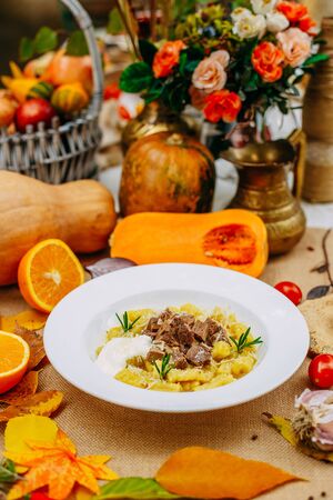 Autumn table setting with pumpkins. Thanksgiving dinner.sliced ââboiled dough with meatの写真素材