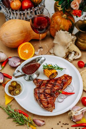 Autumn table setting with pumpkins. Thanksgiving dinner. Steak with Vegetablesの写真素材