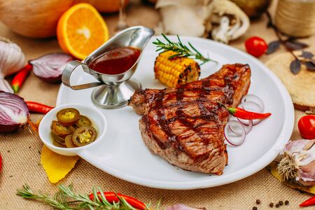Autumn table setting with pumpkins. Thanksgiving dinner. Steak with Vegetablesの写真素材