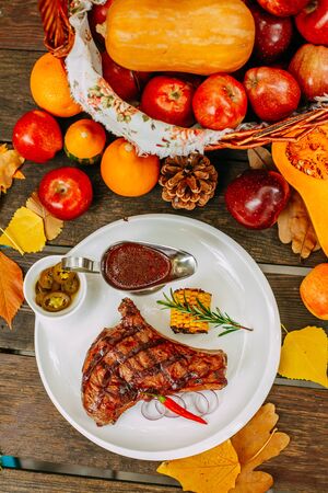 Autumn table setting with pumpkins. Thanksgiving dinner. Steak with Vegetablesの写真素材