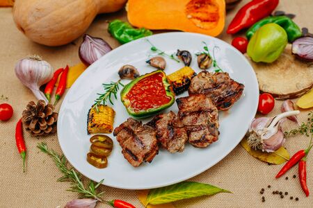 Autumn table setting with pumpkins. Thanksgiving dinner.grilled meat with vegetablesの写真素材