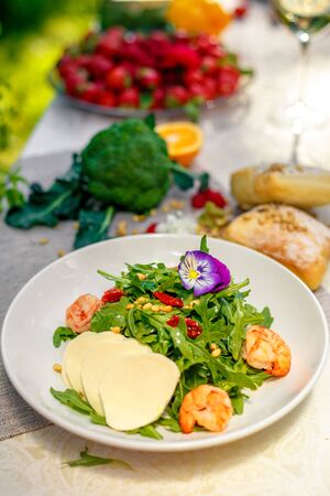 fresh salad with dried meat greens and vegetables on the table, healthy foodの写真素材