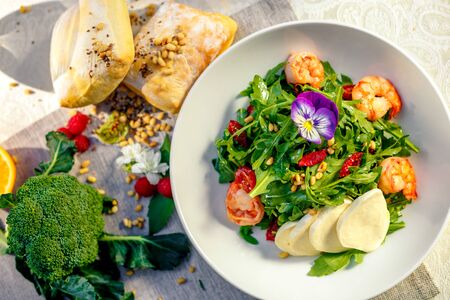 fresh salad with dried meat greens and vegetables on the table, healthy foodの写真素材
