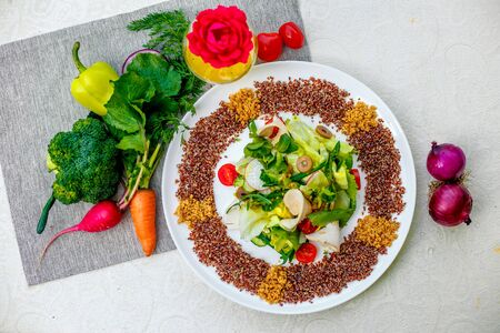 salad with red quinoa and chicken breast with tomatoes served on the table with ingredients, healthy foodの写真素材