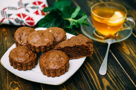 homemade cakes, chocolate muffins with mint and tea with lemonの写真素材