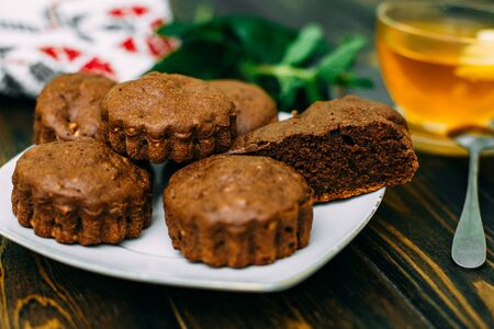 homemade cakes, chocolate muffins with mint and tea with lemonの写真素材