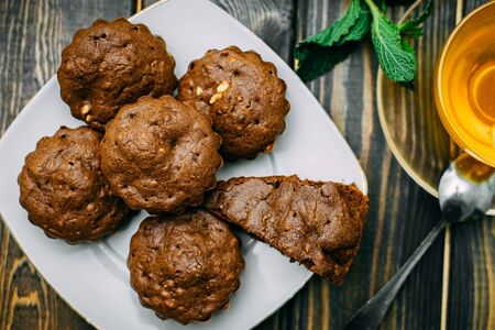 homemade cakes, chocolate muffins with mint and tea with lemonの写真素材