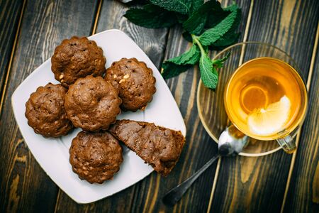 homemade cakes, chocolate muffins with mint and tea with lemonの写真素材