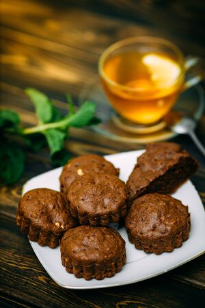 homemade cakes, chocolate muffins with mint and tea with lemonの写真素材