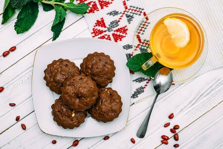homemade cakes, chocolate muffins with mint and tea with lemonの写真素材