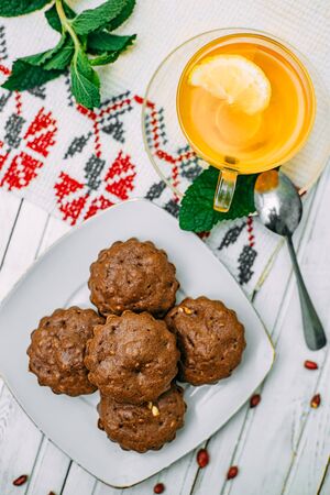 homemade cakes, chocolate muffins with mint and tea with lemonの写真素材