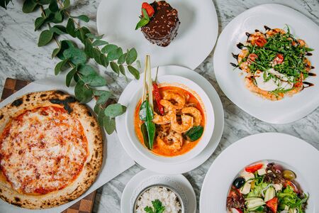 assorted dishes on a marble tableの写真素材