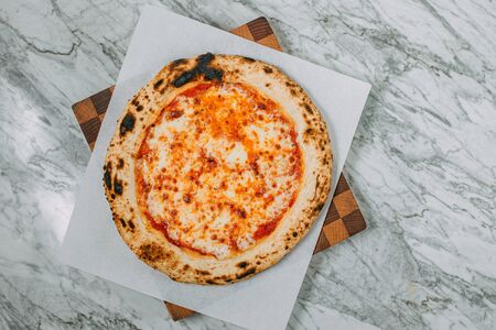 hot italian pizza on marble tableの写真素材