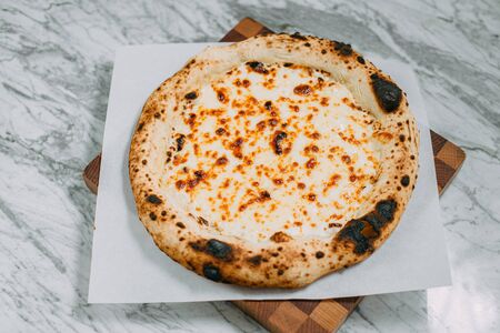 hot italian pizza on marble tableの写真素材