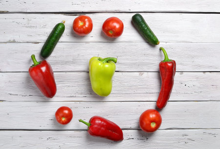 Fresh raw ingredients arranged in a circle on the white rustic wooden table, top view, copy space, selective focusの写真素材