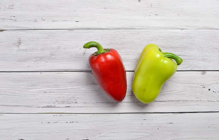 top view of red and yellow peppers on old rustic white wooden table, copy spaceの写真素材