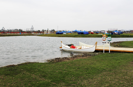 Landscape view of a lakeside with a boat stopping at the sideの写真素材
