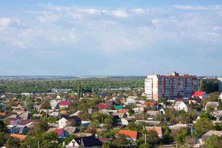 Photo of the city panorama  from the roof of a residential building (9th floor) in spring. There are many trees and one multistorey houseの写真素材