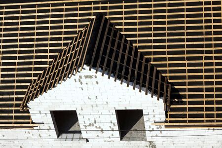 This is a roof of an unfinished house, house facade, top view. Front wall is made from white brick の写真素材