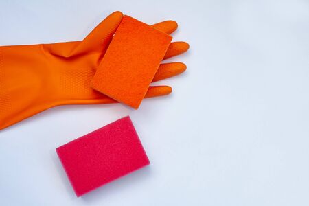 orange glove for cleaning with  orange and red  wisps on a grey background with a copy spaceの写真素材