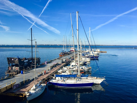 Fishing boats and yachts docked at the seaside in Odessa. Very sunny day