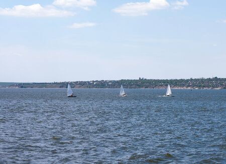 Three sailboats on the river. Its sunny weather outsideの写真素材