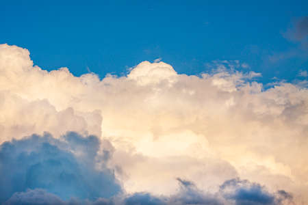Photo of beautiful white and blue fluffy clouds in a bright sunny weatherの写真素材