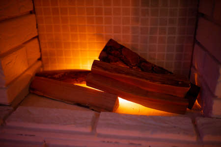 artificial New Year brick white fireplace and home decorated in the evening. Concept of Upcoming 2022 New Year. Calm and peaceful atmosphereの写真素材