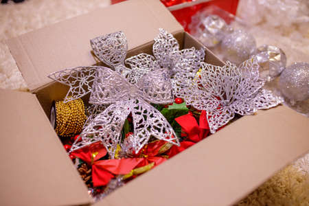 New year elegant decoration Ð± silver glitter flowers and bows. red, yellow and silver colors. Christmas decor concept of festive bright toys. Preparing for the party, Concept of Upcoming 2022 New Yearの写真素材