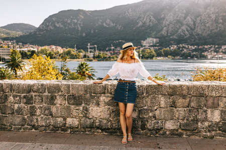 Lady stands near Kotor old wall Fortification in Montenegro.  Tourism in the adriatic sea. Serbian history of balkans, fort and port buildings.の写真素材