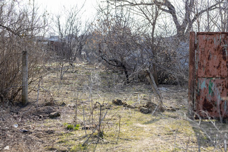 Barmashovo, Ukraine- March 18, 2022: War of Russia against Ukraine. concept of invasion. Damaged house with ruined fence and gate in the center of the village after bomb explosionのeditorial素材