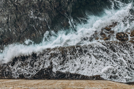 Waves in the Adriatic sea in Budva, Montenegro aquamarine water and stone castle . Tourism and...