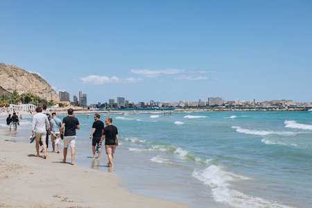 Alicante, Spain - May 16, 2023: People relaxing, walking along the beach seaside promenade shore. These are the most beautiful views. Summer Costa Blanca holidays. trip concept. popular spanish cityのeditorial素材