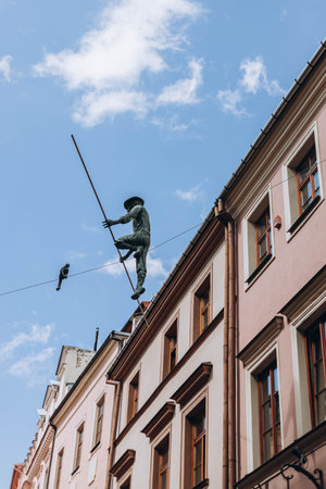 Lublin, Poland- May 10, 2023: Sculpture of Rope Walkers at highline at Market Square. Equilibrist or balance master in old town. The view of the statue in the city center on the old streetのeditorial素材