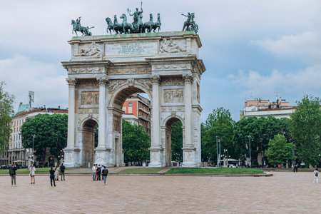 Milan, Italy- May 13, 2023: Arch of Peace or Sempione Gate in Milan, near Sempione Park. Exterior view of the marble gate of the Arco della Sempione, a peace memorial in Milan. Visiting from the park.のeditorial素材