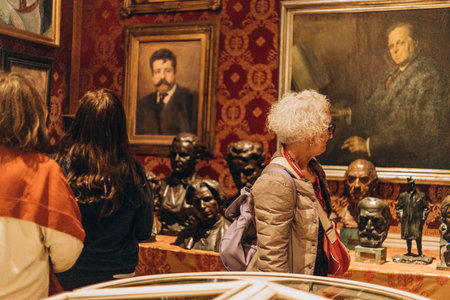 Milan, Italy- May 13, 2023: tourists admires expositions, art in Teatro alla Scala Opera House. The museum at the theatre. Beautiful interior design with pictures , Cultural entertainment, art galleryのeditorial素材
