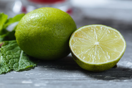 Two fresh organic lime on the table with wooden background