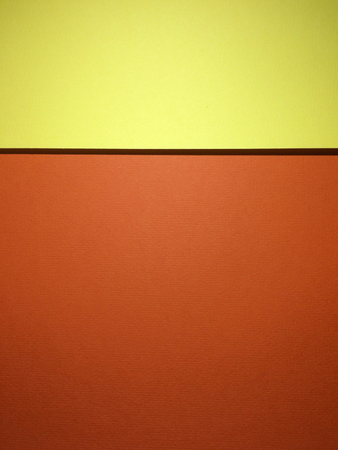 Two colors tone textured papers abstract background with copy space. Orange and yellow version. Rule of thirds used.の写真素材