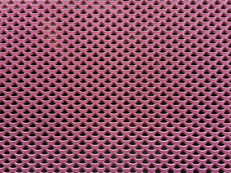 Pink metallic grid pattern closeup photo.