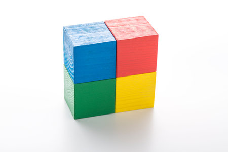 Stack of four colorful cubes isolated on white background.