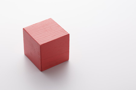 Red wooden cube isolated on white background.の写真素材