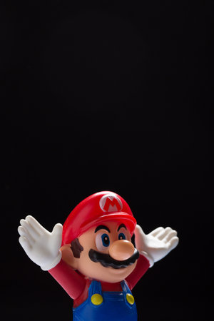 Moscow, Russia - September 24, 2021: Plastic figure of Mario from Nintendo video game isolated on black background.のeditorial素材