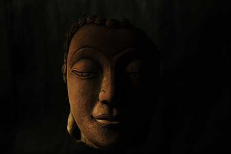 Buddha head on black backgroundの写真素材