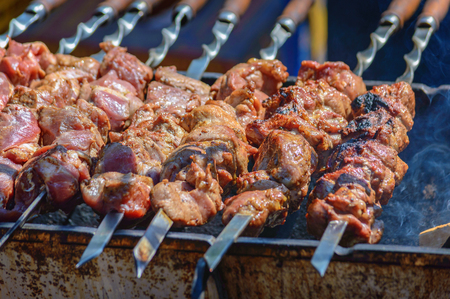 cooking meat on skewers, shashlik on coalsの写真素材